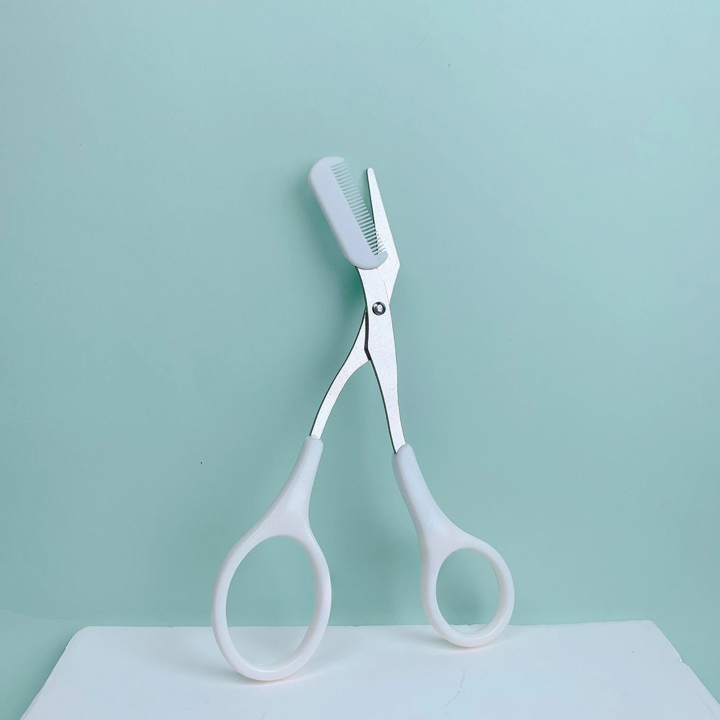 Pink eyebrow trimming scissors with built-in comb - stainless steel, precise grooming tool, creating perfect eyebrows Beauty World Shop